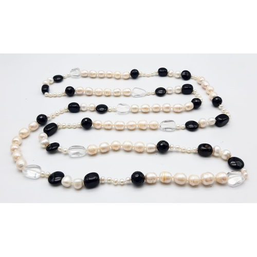 1624 - A Rope Length Cultured Pearl and Onyx Necklace. 136cm length.