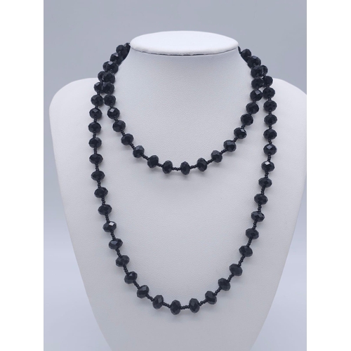 1642 - A Black Jet Jewellery Set. To include: faceted beaded necklace - 82cm. Drop earrings - 5cm and oval ... 