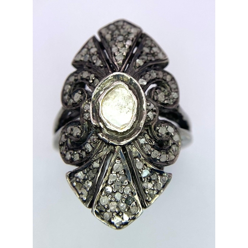 168 - An Edwardian, ART NOUVEAU sterling silver ring with a large natural untreated diamond surrounded by ... 