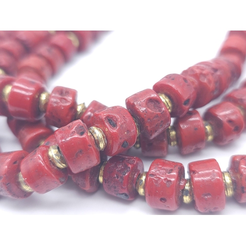 1691 - A Three Row Blood Red African Coral Necklace. Rondelle coral beads with gilded spacers. 44-48cm.