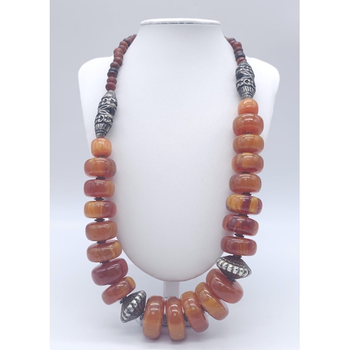 1710 - A Tibetan Style Amber Resin Necklace - With an antique style carnelian cuff bracelet and pendant ear... 