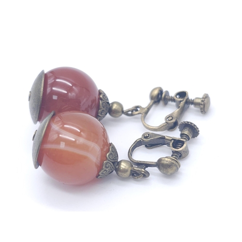 1710 - A Tibetan Style Amber Resin Necklace - With an antique style carnelian cuff bracelet and pendant ear... 