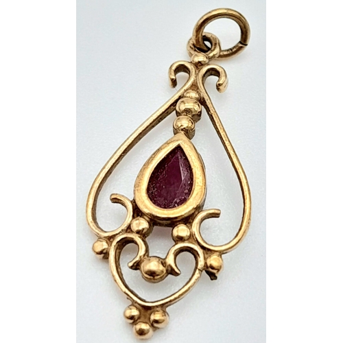 1715 - An Art Deco Style 9K Gold and Ruby Pendant. 25mm. 1g total weight.