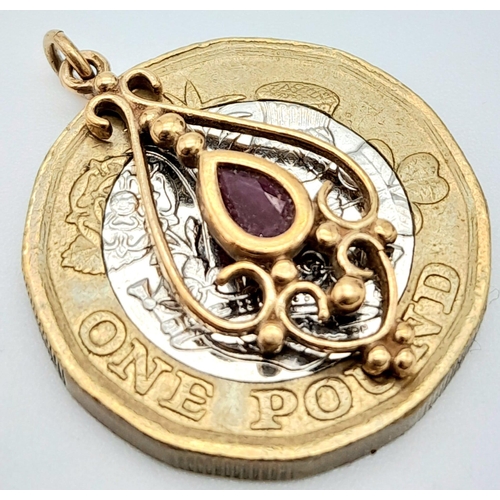 1715 - An Art Deco Style 9K Gold and Ruby Pendant. 25mm. 1g total weight.