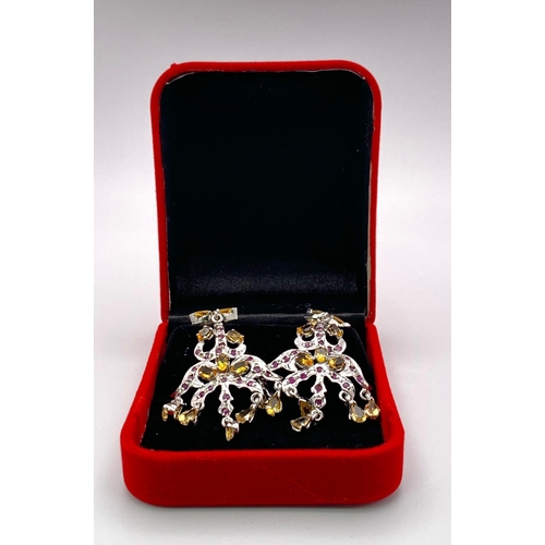 184 - A Pair of Ruby and Citrine Spectre Drop Earrings. Set in 925 silver. Ruby & Citrine - 13ctw. 12.4g t... 