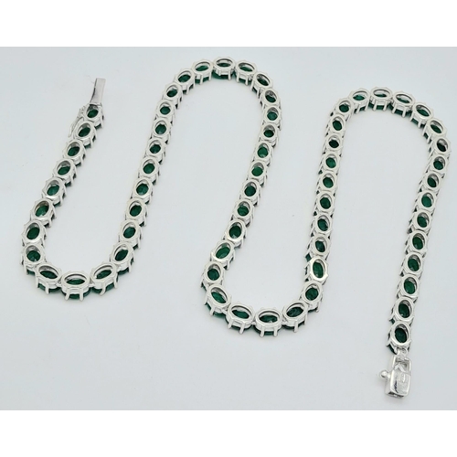 34 - An Emerald Gemstone Tennis Necklace set in 925 Silver. 47cm length. 40g total weight.