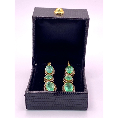 377 - A Pair of Emerald Gemstone Drop Earrings. Each emerald having a halo of Diamonds. Emeralds - 10ctw a... 