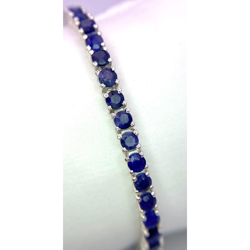 436 - A Round-Cut Blue Sapphire Gemstone Tennis Bracelet set in 925 Silver. 18cm length. 16.8g total weigh... 