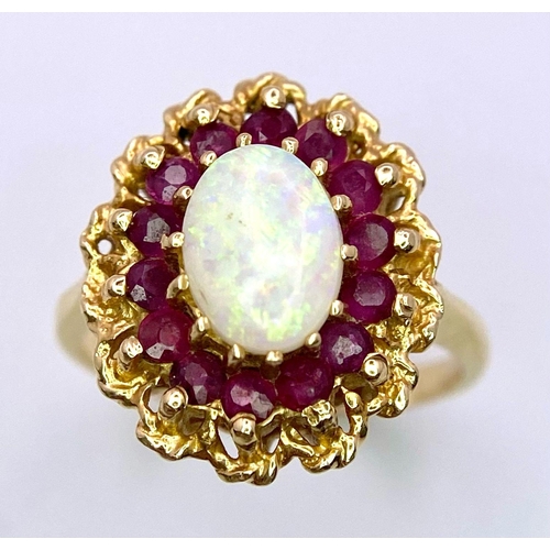 50 - A Beautiful Vintage 14k Yellow Gold, Opal and Ruby Ring. Central oval colour-play opal with a halo o... 