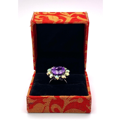 799 - An Amethyst, Opal and Diamond 925 Silver Ring. Central oval amethyst with a diamond and opal halo. D... 