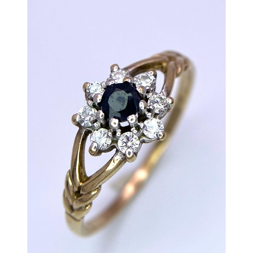 874 - A Vintage 9K Yellow Gold, Sapphire and CZ Ring. Small central sapphire with a CZ halo. Size M/N. 1.2... 