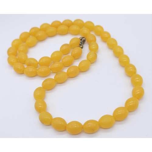 898 - A Vintage Amber Bakelite Bead Necklace and Earring Set. Necklace - 70cm. 3cm earring drop.