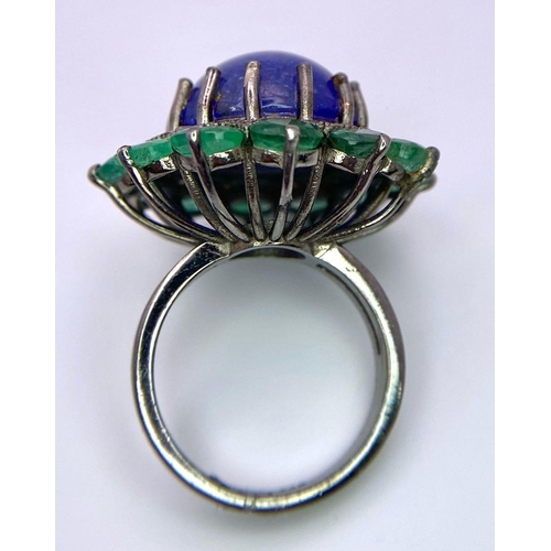 956 - A 11.80ct Tanzanite Cabochon Gemstone Ring with halos of 3.5ctw Emeralds and 0.70ctw Diamonds. Set i... 