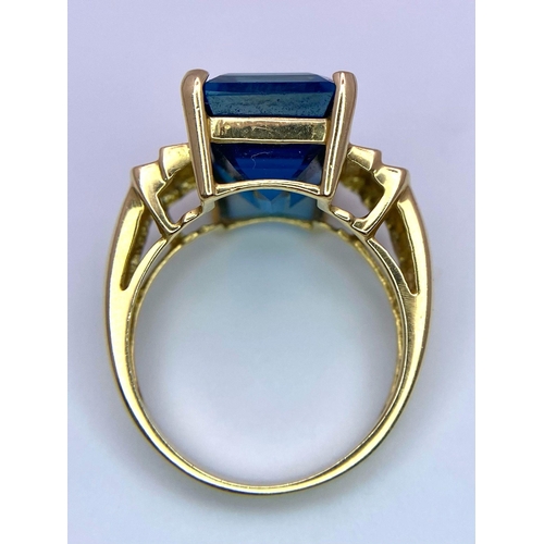 989 - A 14K Yellow Gold (tested) Topaz Ring. Rectangular cut topaz on a raised setting. Size M. 5.2g total... 