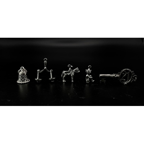 1703 - Collection of white metal Charms/Pendants.
Featuring a 21 Key, Scales, Horse & Rider, Bell and a che... 