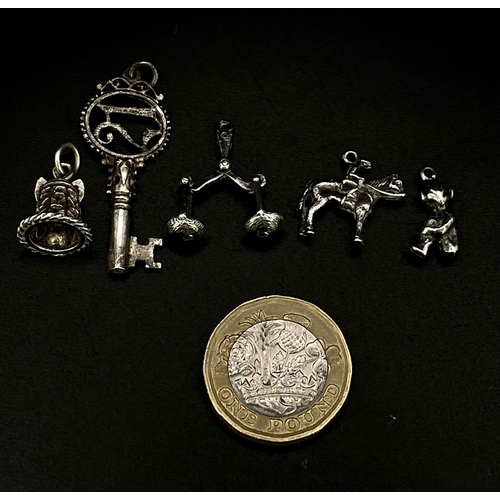 1703 - Collection of white metal Charms/Pendants.
Featuring a 21 Key, Scales, Horse & Rider, Bell and a che... 