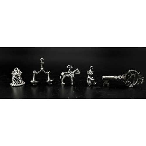 1703 - Collection of white metal Charms/Pendants.
Featuring a 21 Key, Scales, Horse & Rider, Bell and a che... 