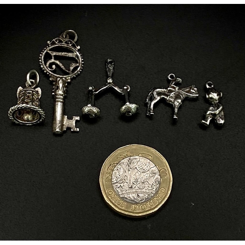 1703 - Collection of white metal Charms/Pendants.
Featuring a 21 Key, Scales, Horse & Rider, Bell and a che... 