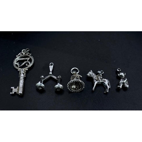 1703 - Collection of white metal Charms/Pendants.
Featuring a 21 Key, Scales, Horse & Rider, Bell and a che... 