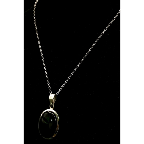 1146 - A Black Onyx Pendant Set in Silver on a Silver Chain. 4cm and 42cm.