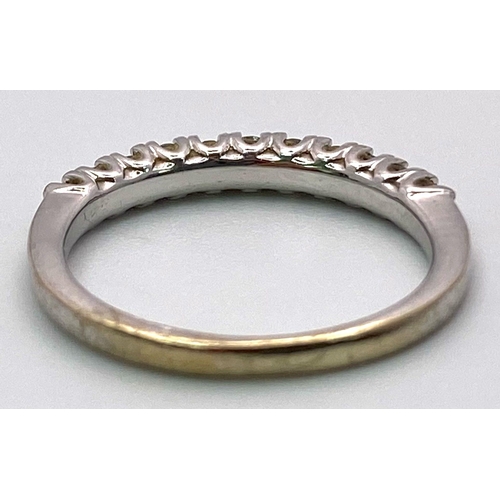 1543 - A 9K White Gold and Diamond Half Eternity Ring. Size I. 1.47g total weight. 0.25ctw