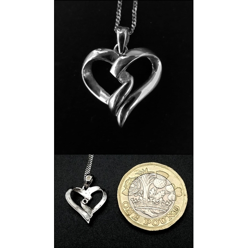 1466 - A 9K White Gold Heart Pendant on a 9K White Disappearing Necklace. 17mm and 44cm. 1.82g total weight... 