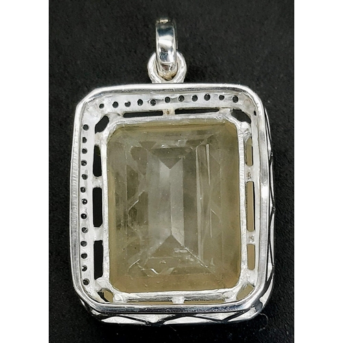 1063 - A 60ct Heliodor Yellow Beryl (25x20mm) Pendant on 925 Silver with White Topaz Surround.  AIG Milan C... 