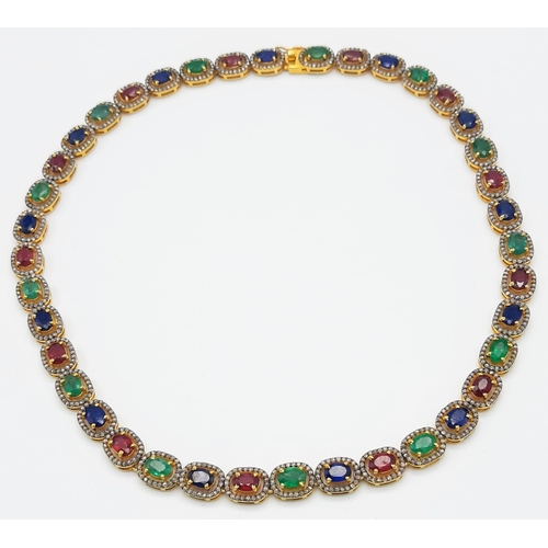 1377 - An Emerald, Sapphire and Ruby Tennis Necklace set in 925 Gilded Silver. Each gemstone with diamond s... 