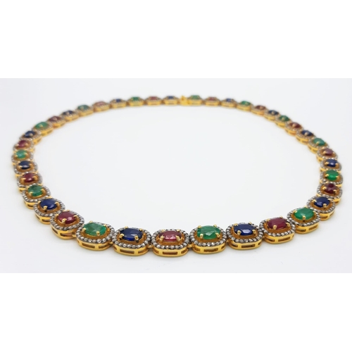 1377 - An Emerald, Sapphire and Ruby Tennis Necklace set in 925 Gilded Silver. Each gemstone with diamond s... 