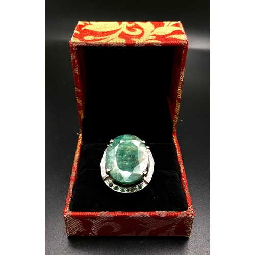 1123 - An Oval Slice Natural Emerald 925 Silver Ring with Emerald Accents. 20ct Emerald. Size Q. 14.88g tot... 