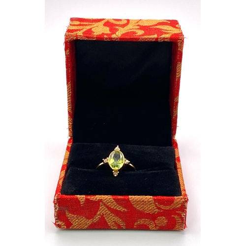 1176 - An Oval Peridot and Diamond Ring. A lime green peridot with compass point diamond accents. Set in gi... 