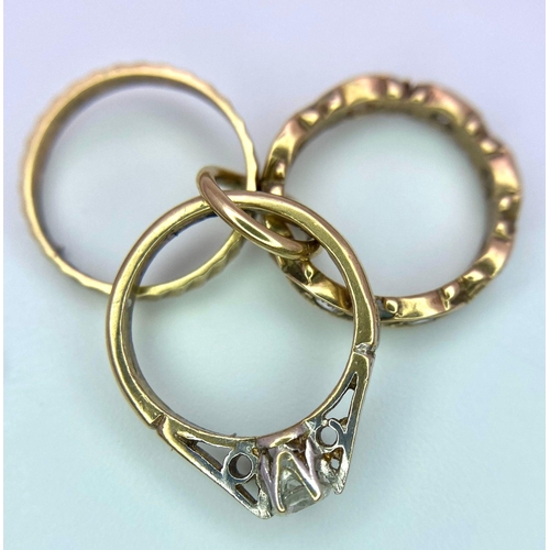 1683 - A 9K Yellow Gold Three Ring Charm. Three miniature different style rings. 2.42g total weight.