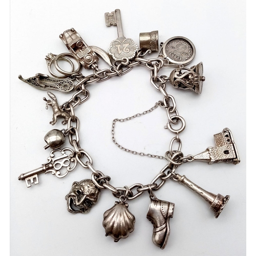 1787 - A well collected, white metal Charm Bracelet.
Full of eclectic charms, some stand-outs include a 189... 