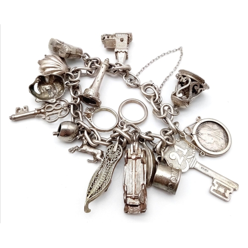 1787 - A well collected, white metal Charm Bracelet.
Full of eclectic charms, some stand-outs include a 189... 