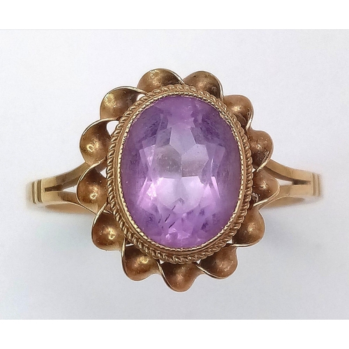 450 - A Vintage 9K Yellow Gold Amethyst Ring. Central oval amethyst in a twist setting. Size P. 2.75g weig... 