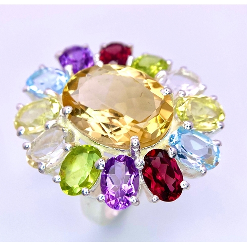 1266 - An Amethyst, Garnet, Citrine and Peridot Floral Dress Ring. Set in 925 Silver. Size Q/R. 10.8g weigh... 