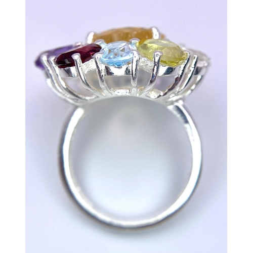 1266 - An Amethyst, Garnet, Citrine and Peridot Floral Dress Ring. Set in 925 Silver. Size Q/R. 10.8g weigh... 