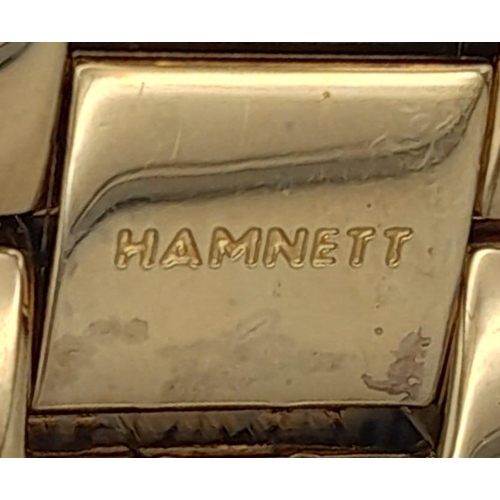 1387 - A Vintage Hamnett Ladies Watch. 
Gold Tone stainless steel with set crystals, unworn with protective... 