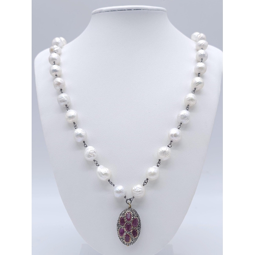 382 - A Baroque Pearl Necklace with an Antique Style Ruby Bead and Pave Set Diamond Drop Pendant. Set in 9... 