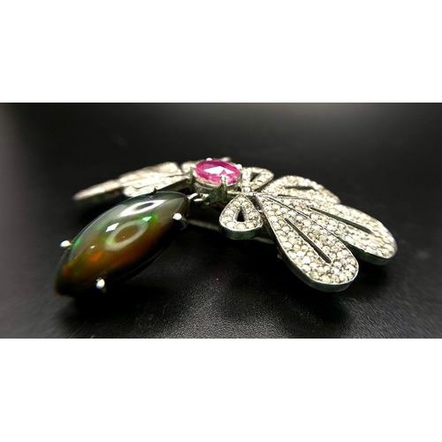 45 - An Extraordinary, Diamond, Black Opal and Ruby Brooch. An 8ct Black fire Opal hangs from 3.7ctw of d... 