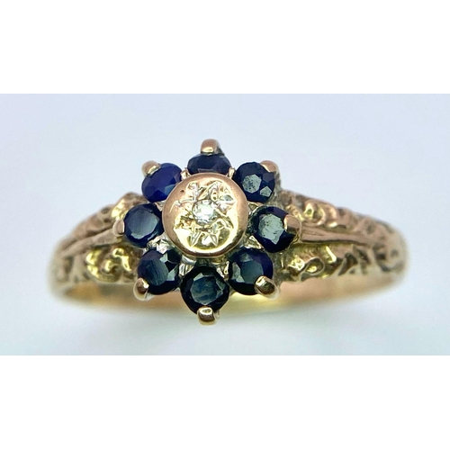 850 - A Vintage 9K Yellow Gold Sapphire and Diamond Ring. Small central diamond with a sapphire halo. Size... 