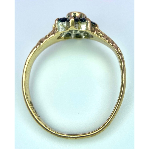 850 - A Vintage 9K Yellow Gold Sapphire and Diamond Ring. Small central diamond with a sapphire halo. Size... 