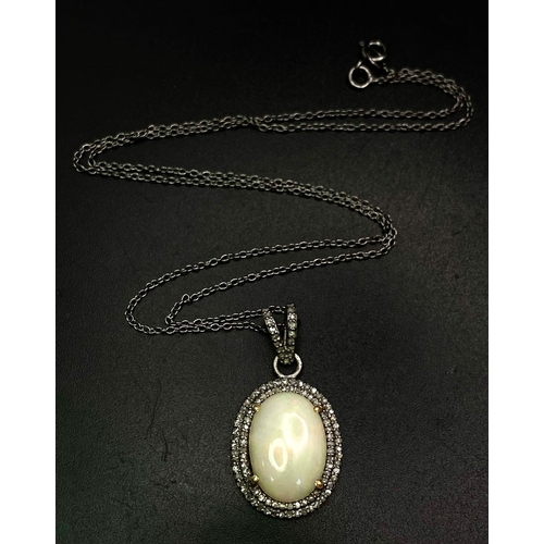 1070 - A Beautiful Colour-Play Opal Pendant with Two Surrounds of Diamond Accents. 5ct opal cabochon. Set i... 