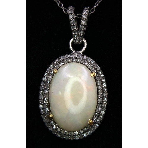 1070 - A Beautiful Colour-Play Opal Pendant with Two Surrounds of Diamond Accents. 5ct opal cabochon. Set i... 