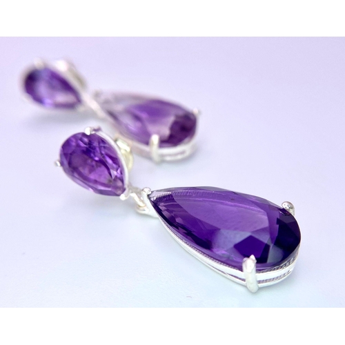 1298 - A Pair of Amethyst Pear-Shape Drop Earrings set in 925 Silver. One slightly deeper in colour than th... 