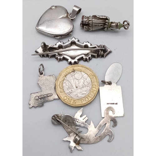 1401 - An eclectic parcel of Sterling Silver Jewellery.
Two ornately engraved brooches, a love-heart locket... 