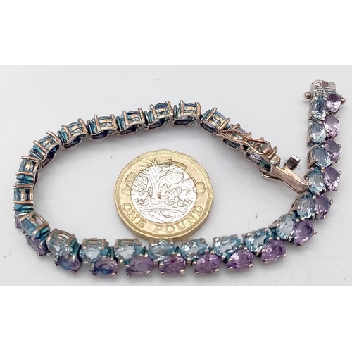 1606 - A Sterling Silver, double row bracelet set with Amethyst and Topaz. Measures 20cm in length.
Weight:... 