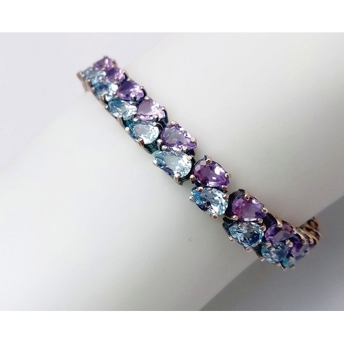 1606 - A Sterling Silver, double row bracelet set with Amethyst and Topaz. Measures 20cm in length.
Weight:... 