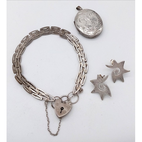 1772 - A Parcel of Sterling Silver Jewellery.
Consisting of a unique oval chain, love heart lock bracelet (... 