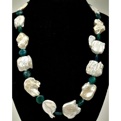 196 - A highly unusual necklace and earrings set with large natural white baroque pearls alternating with ... 